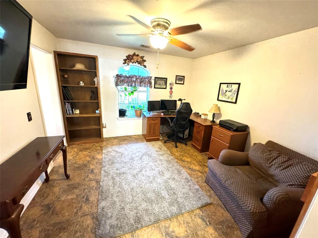 505 3rd Street Dodd City, TX 75438 - Photo 31 of 37 a living room with furniture and a flat screen tv