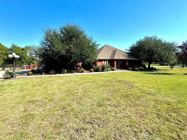 a view of a backyard of the house