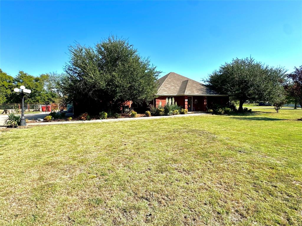 505 3rd Street Dodd City, TX 75438 - Photo 4 of 37 a view of a swimming pool with a lawn chairs under an umbrella