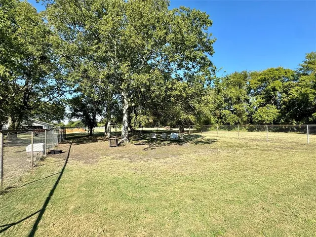 a front view of a house with sitting area and garden