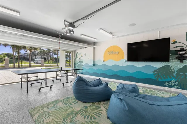 a view of a patio with table and chairs and a barbeque