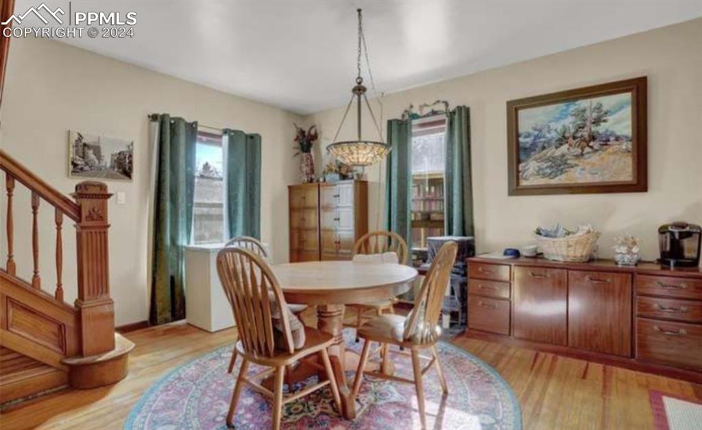 24119 Eccles Street Elbert, CO 80106 - Photo 13 of 23 a view of a dining room with furniture window and wooden floor
