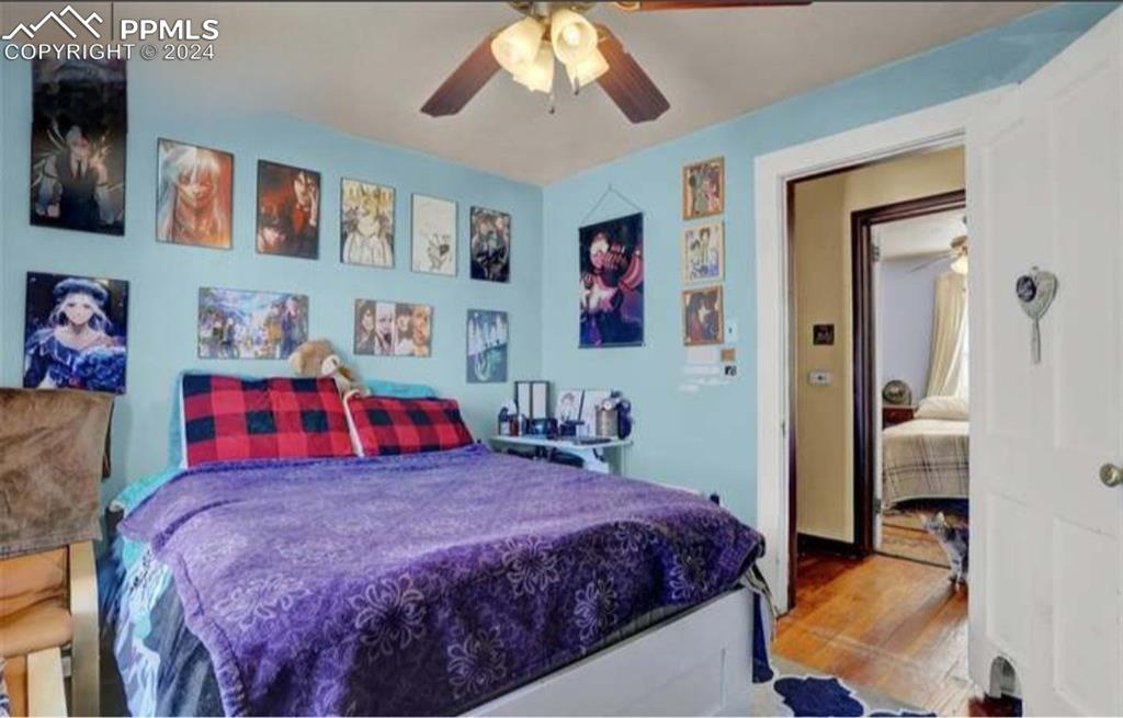 24119 Eccles Street Elbert, CO 80106 - Photo 20 of 23 a bedroom with a bed and a painting on the wall
