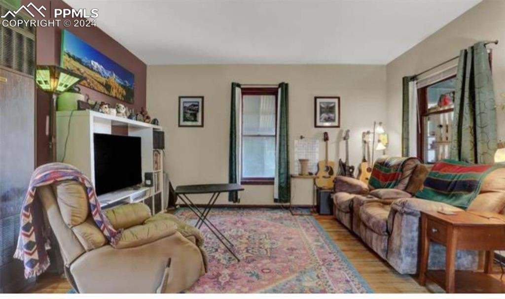 24119 Eccles Street Elbert, CO 80106 - Photo 6 of 23 a living room with furniture and a flat screen tv
