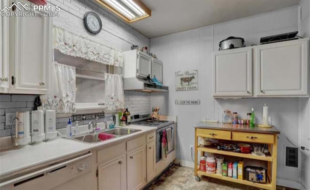 24119 Eccles Street Elbert, CO 80106 - Photo 8 of 23 a kitchen with stainless steel appliances a stove a sink and cabinets