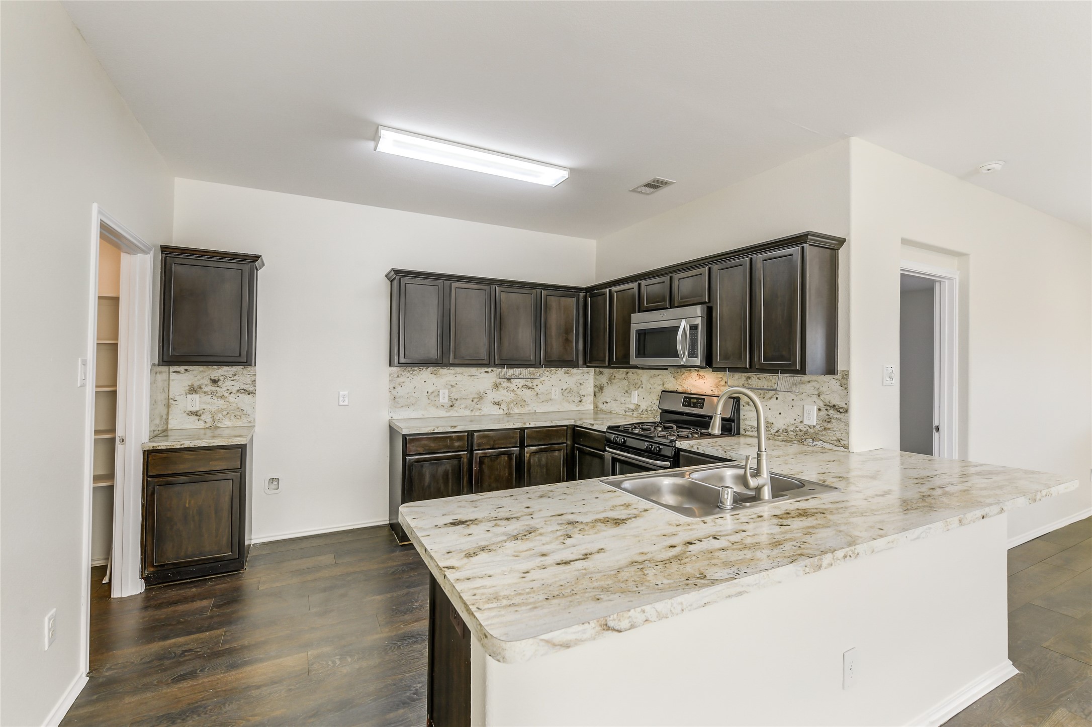 2023 Louetta Mist Drive Spring, TX 77388 - Photo 13 of 39 a kitchen with stainless steel appliances granite countertop a sink stove and refrigerator