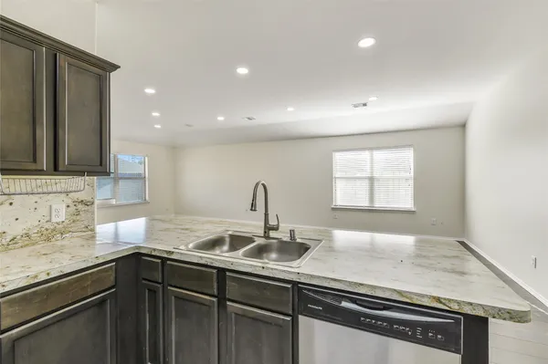 a kitchen with stainless steel appliances granite countertop a sink stove and cabinets