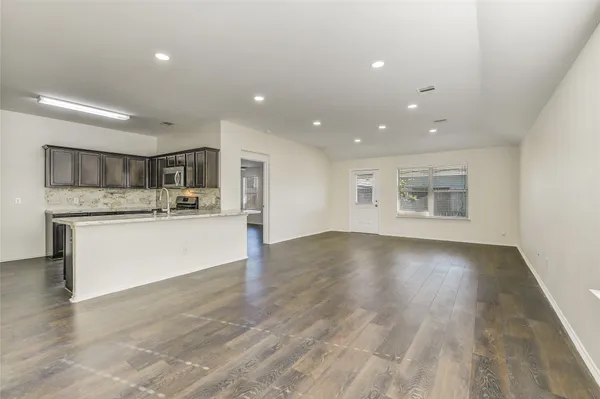 a view of kitchen with cabinets and wooden floor