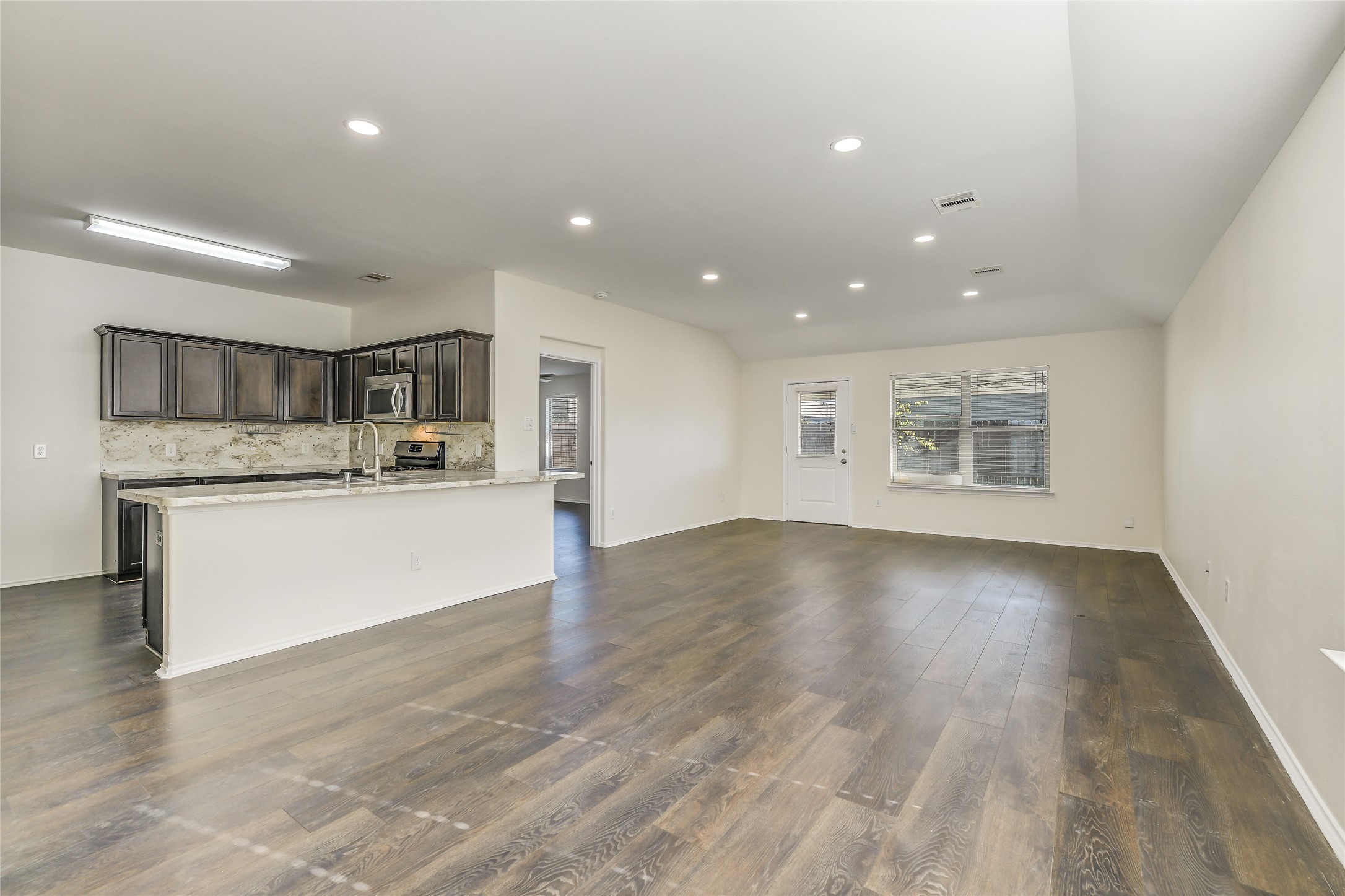 2023 Louetta Mist Drive Spring, TX 77388 - Photo 20 of 39 a view of kitchen with cabinets and wooden floor