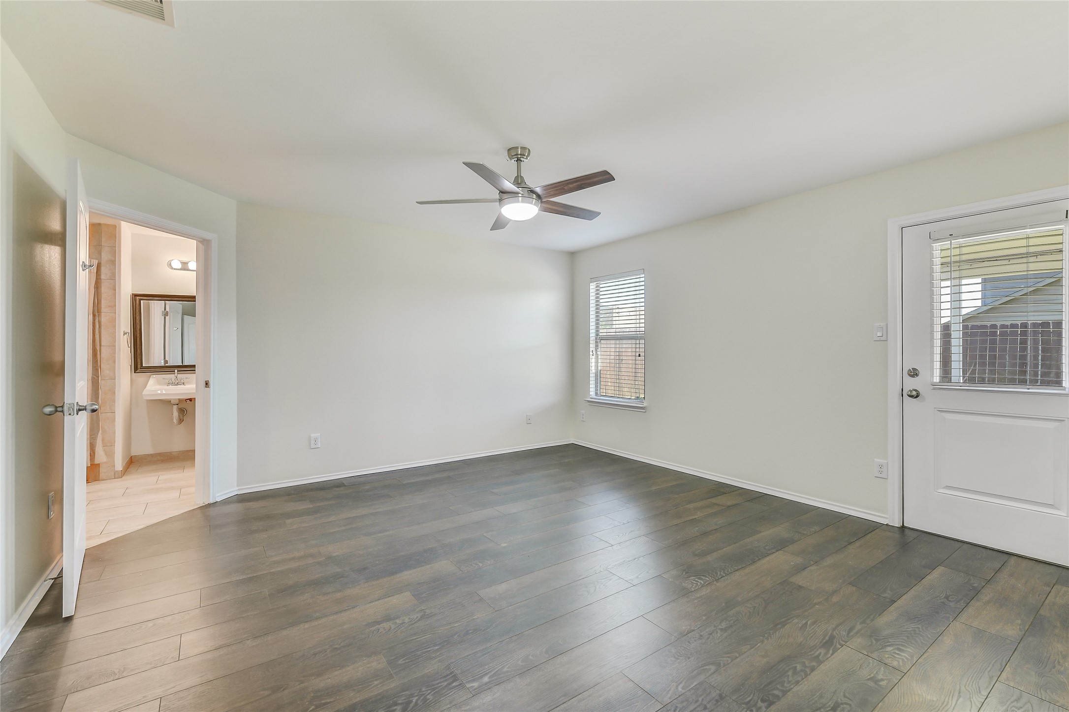 2023 Louetta Mist Drive Spring, TX 77388 - Photo 26 of 39 an empty room with wooden floor and ceiling fan
