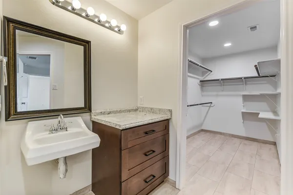 a bathroom with a granite countertop sink mirror and shower
