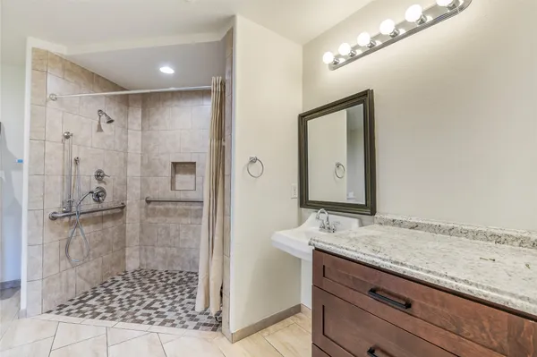a bathroom with a glass shower door