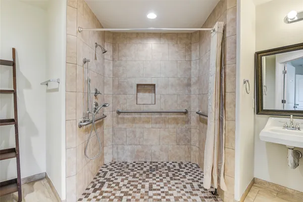 a bathroom with a shower and a sink