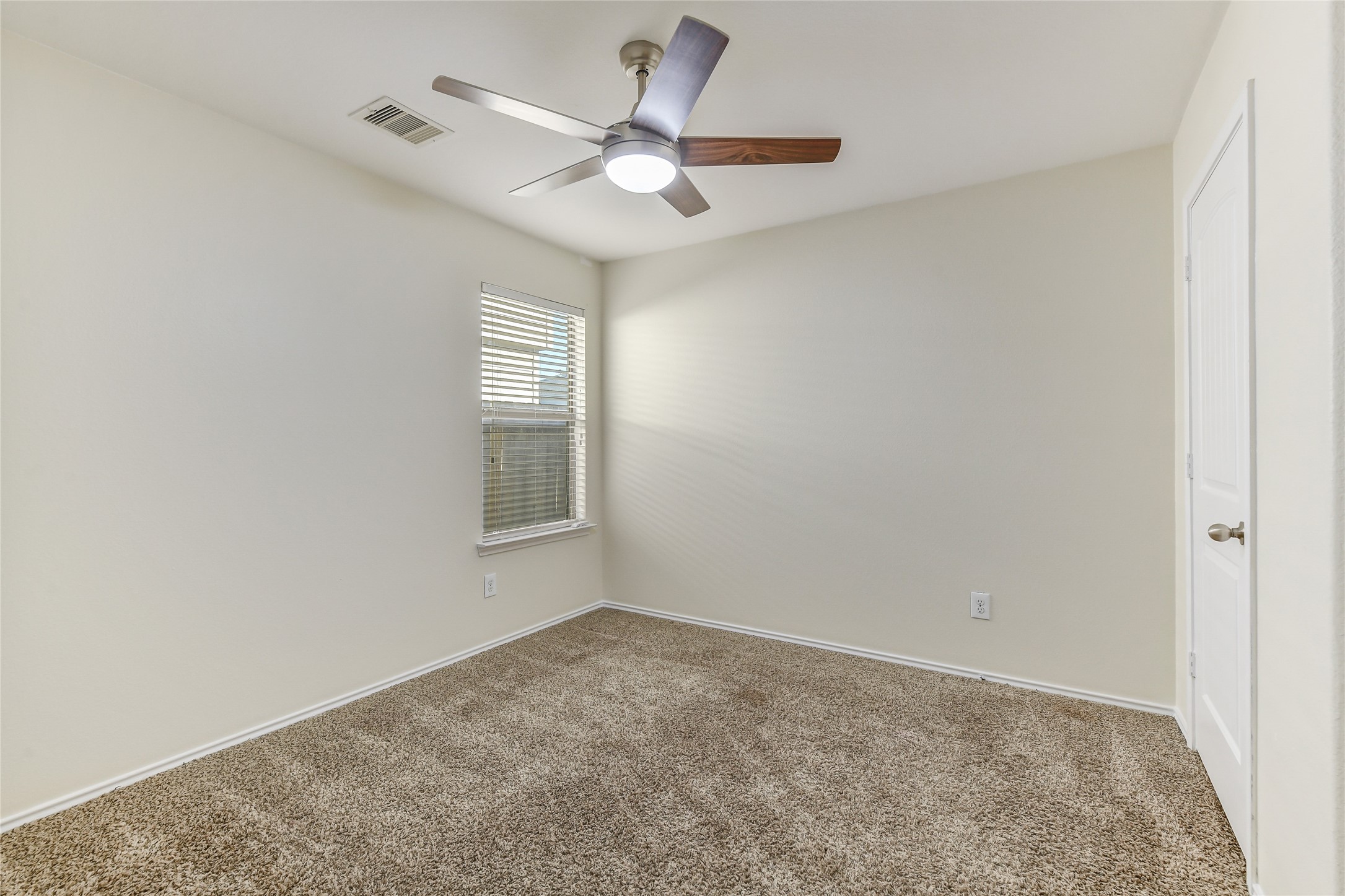2023 Louetta Mist Drive Spring, TX 77388 - Photo 34 of 39 an empty room with a window and a fan