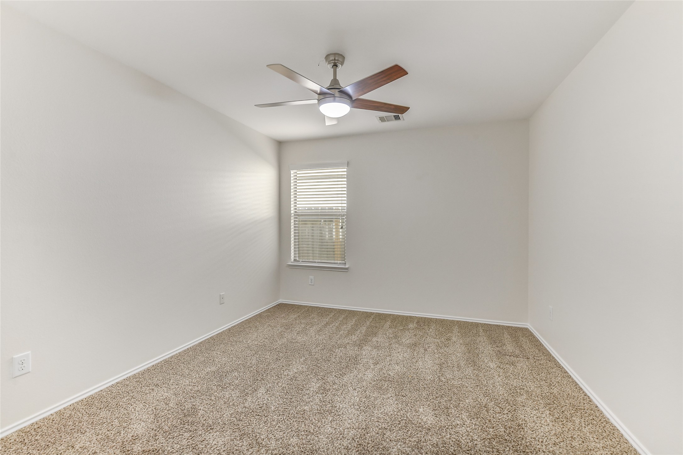 2023 Louetta Mist Drive Spring, TX 77388 - Photo 37 of 39 an empty room with a window and a fan