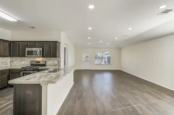 a kitchen with a stove a sink and a refrigerator