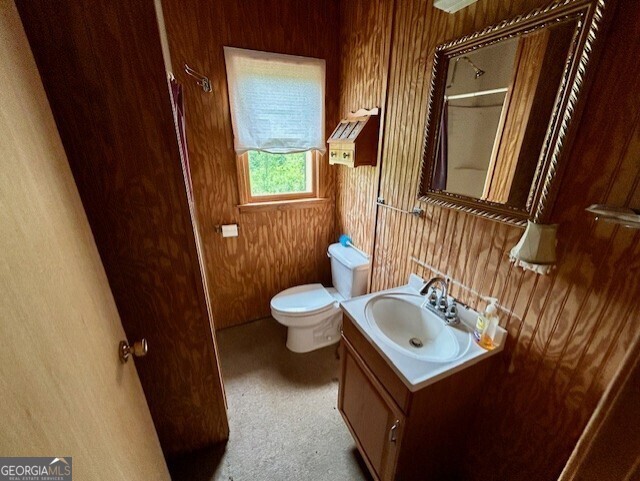 289 Hunting Club Road Southwest Crawfordville, GA 30631 - Photo 11 of 23 a bathroom with a sink a toilet and a mirror