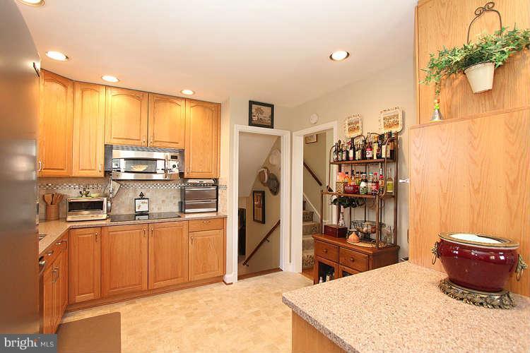 508 Derrydown Lane Silver Spring, MD 20904 - Photo 11 of 30 a kitchen with stainless steel appliances kitchen island granite countertop a refrigerator a stove and a sink with cabinets