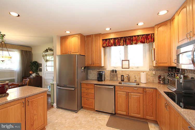 508 Derrydown Lane Silver Spring, MD 20904 - Photo 12 of 30 a kitchen with sink a refrigerator and cabinets