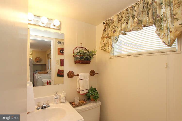 508 Derrydown Lane Silver Spring, MD 20904 - Photo 26 of 30 a bathroom with a sink and mirror with toilet