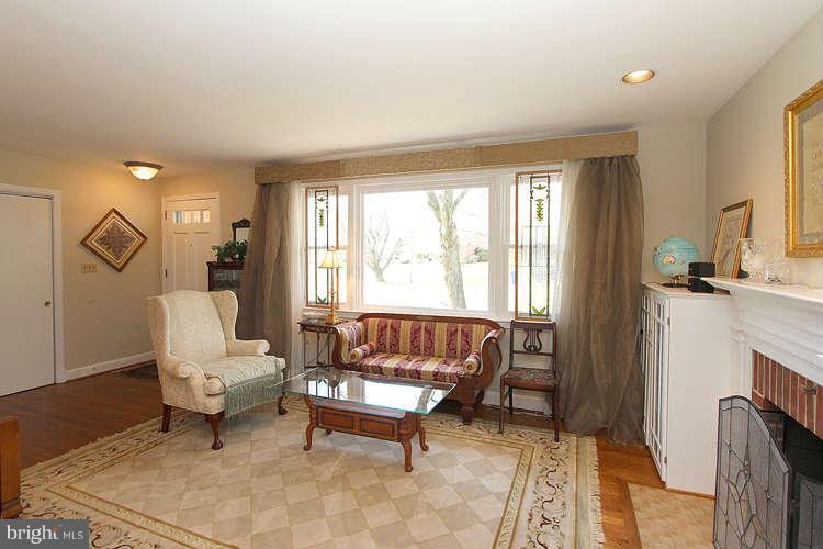 508 Derrydown Lane Silver Spring, MD 20904 - Photo 6 of 30 a living room with furniture a fireplace and a large window