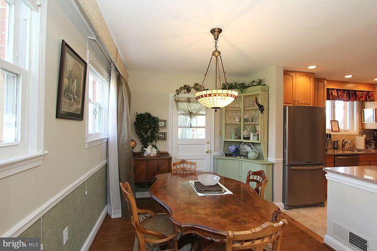 508 Derrydown Lane Silver Spring, MD 20904 - Photo 7 of 30 a view of a dining room with furniture a chandelier and wooden floor