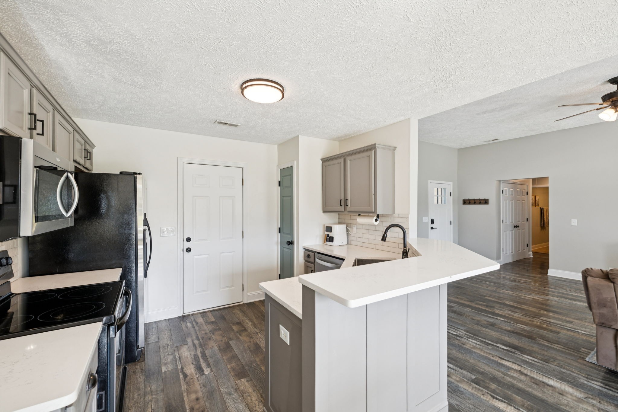 1169 Mantle Way Murfreesboro, TN 37129 - Photo 14 of 45 a room with stainless steel appliances kitchen island a sink dishwasher a refrigerator and a stove with wooden floor