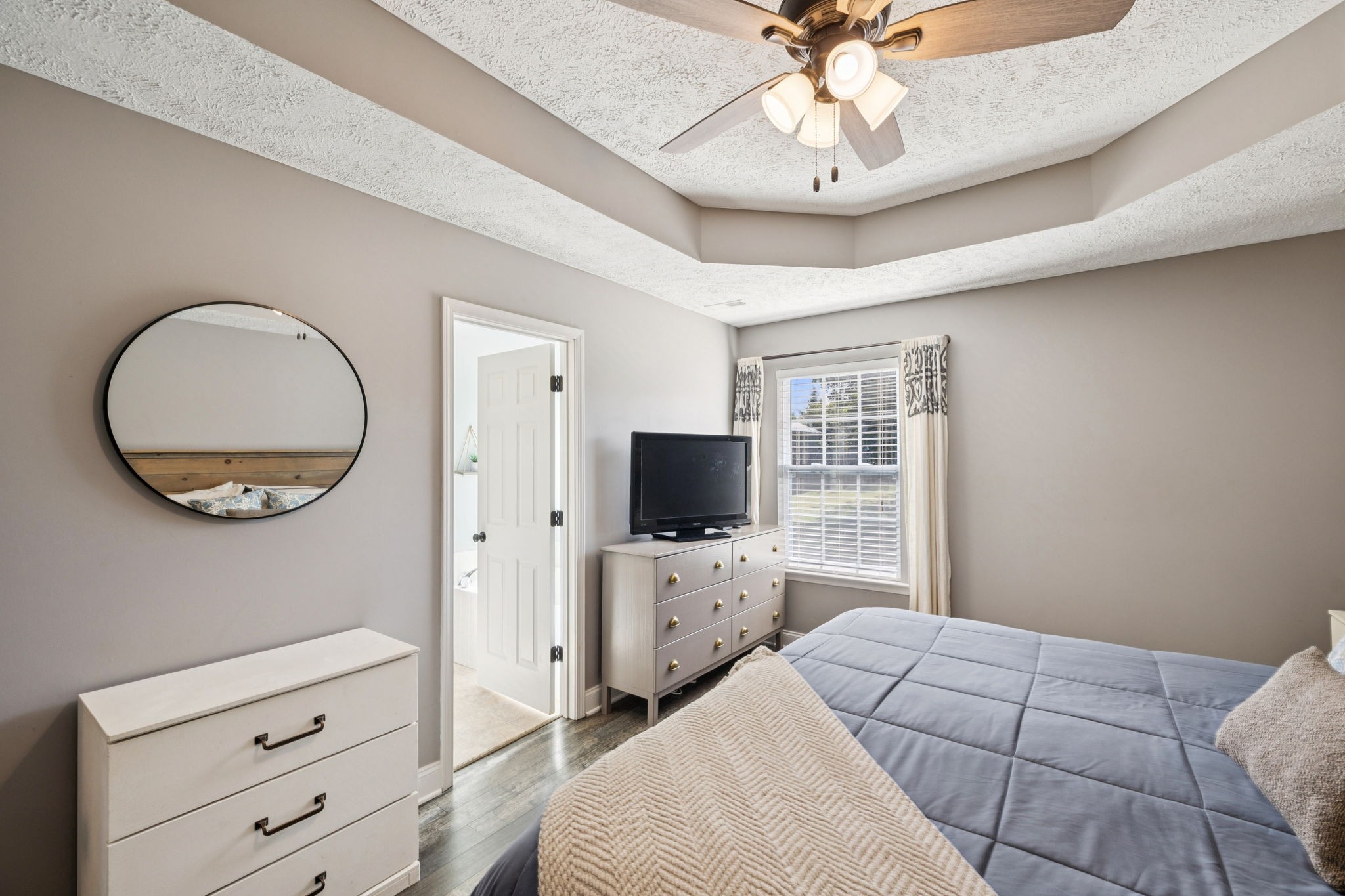 1169 Mantle Way Murfreesboro, TN 37129 - Photo 24 of 45 a bedroom with a bed a mirror on dresser and a chandelier