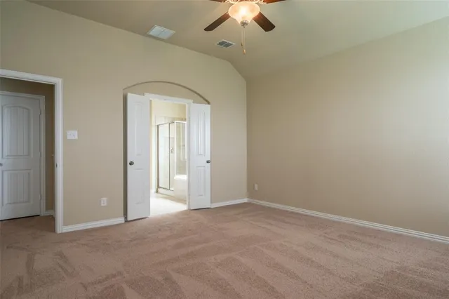an empty room with a empty space and a ceiling fan