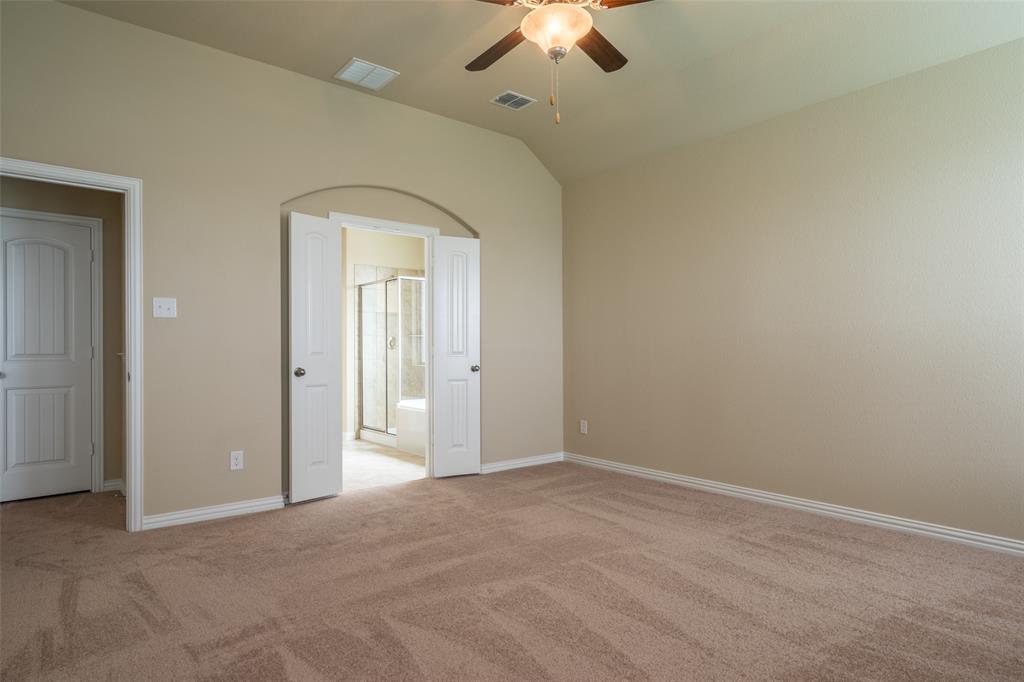 2401 Austin Lane Prosper, TX 75078 - Photo 11 of 36 Unfurnished bedroom with light carpet, vaulted ceiling, a ceiling fan, and connected bathroom