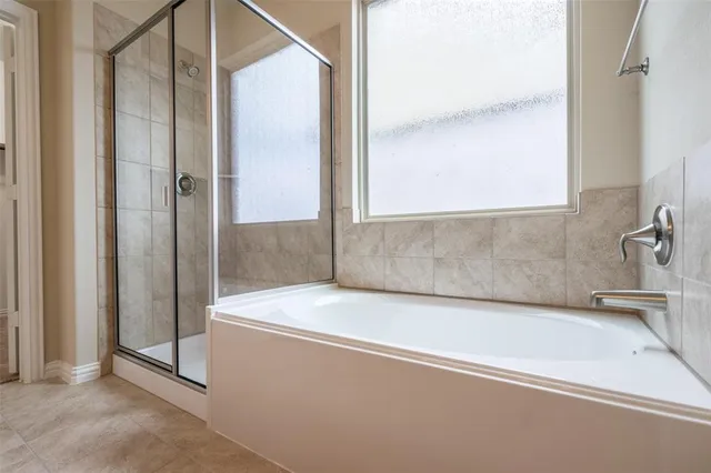 a bathroom with a bathtub and a shower