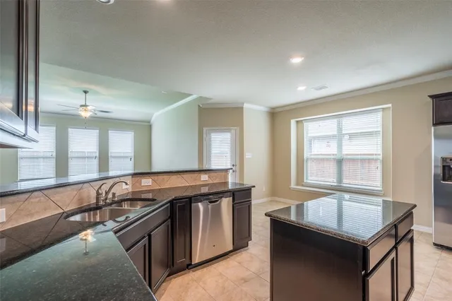 a kitchen with stainless steel appliances granite countertop a sink stove and cabinets