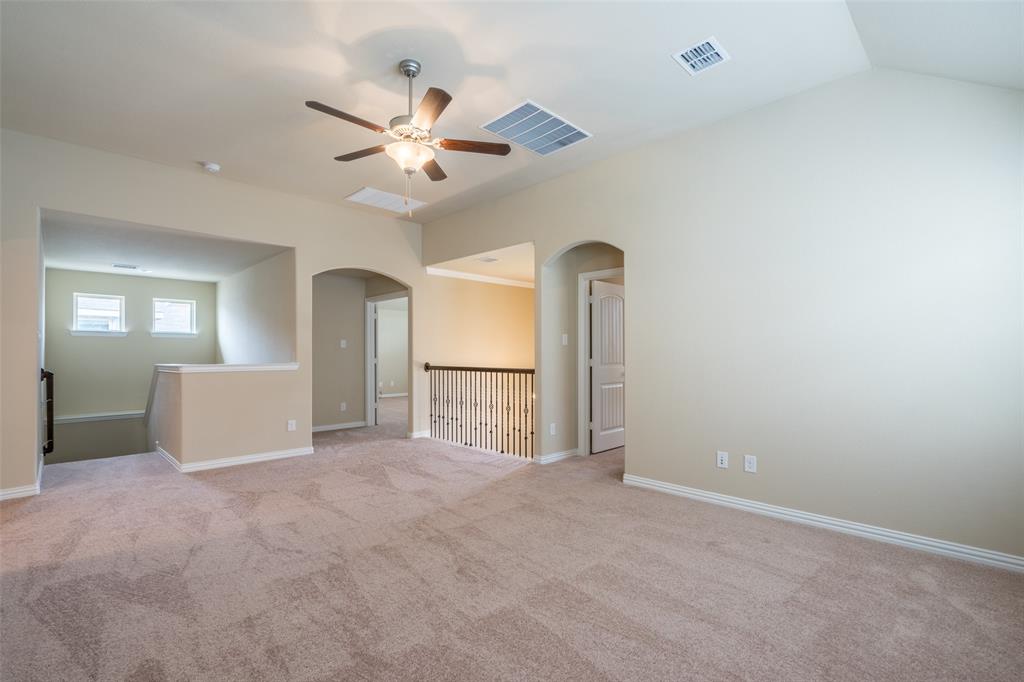 2401 Austin Lane Prosper, TX 75078 - Photo 26 of 36 Carpeted spare room featuring a ceiling fan and arched walkways