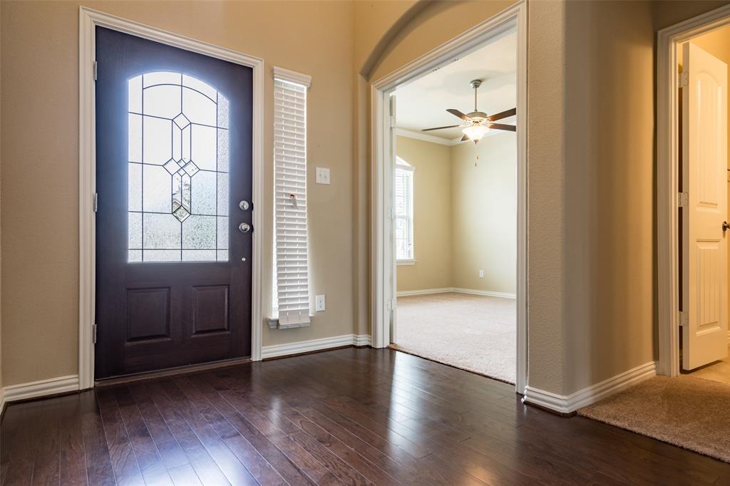 2401 Austin Lane Prosper, TX 75078 - Photo 3 of 36 Entrance foyer with dark wood finished floors, ceiling fan, and crown molding