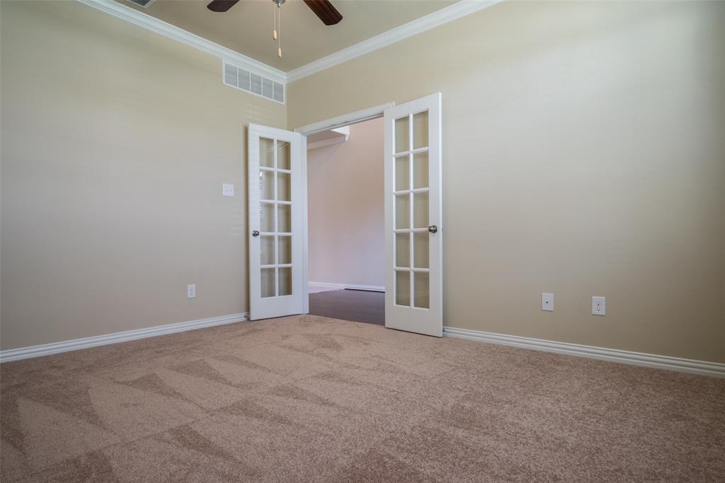2401 Austin Lane Prosper, TX 75078 - Photo 5 of 36 Carpeted spare room with ornamental molding, a ceiling fan, and french doors