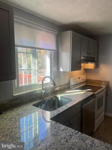 a view of a livingroom with wooden floor and a window