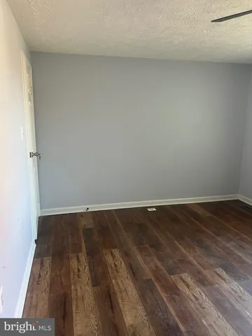 a view of an empty room and wooden floor
