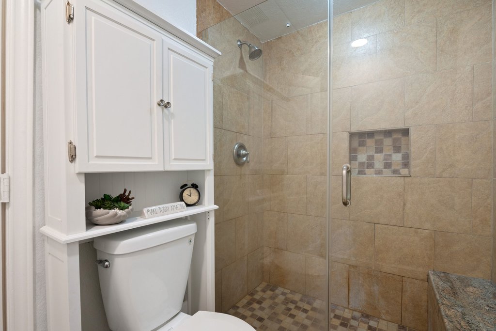1910 Robbins Place, Unit 106 Austin, TX 78705 - Photo 11 of 20 a bathroom with a toilet a sink a bath tub and shower