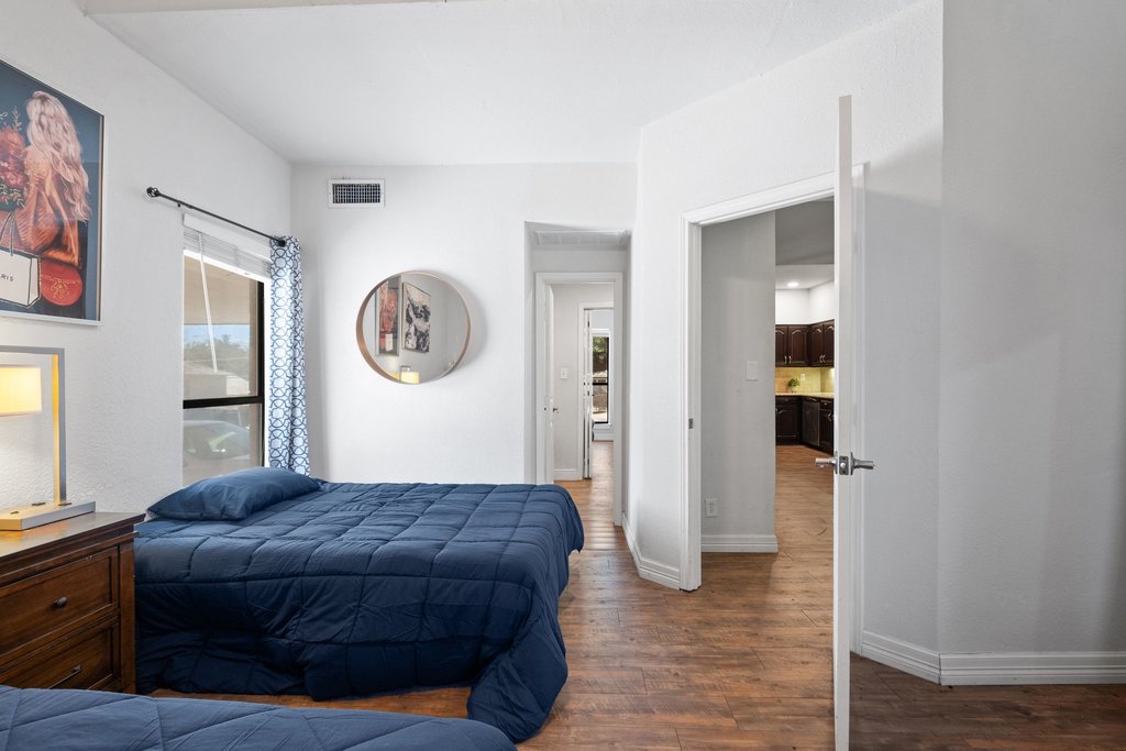 1910 Robbins Place, Unit 106 Austin, TX 78705 - Photo 13 of 20 a spacious bedroom with a bed and a dresser
