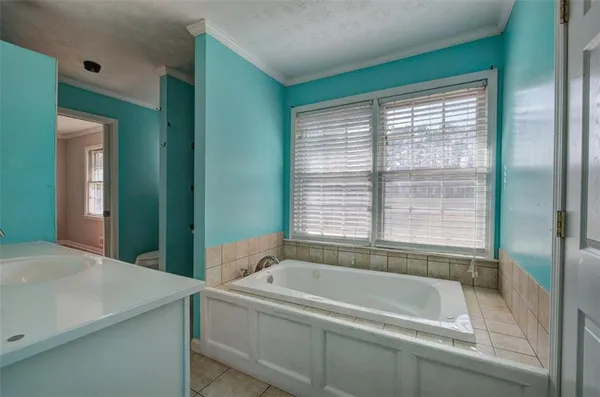 a bathroom with a bathtub and a sink