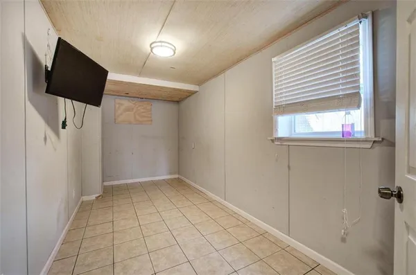 a view of a livingroom with an empty space and a window