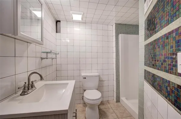 a bathroom with a toilet sink and a mirror