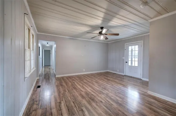 wooden floor in an empty room with a window
