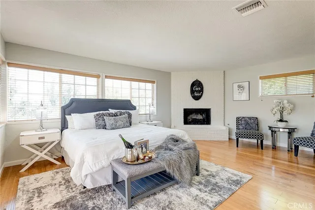 a living room with furniture wooden floor and a fireplace