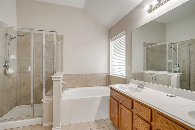 a bathroom with a shower and a bath tub