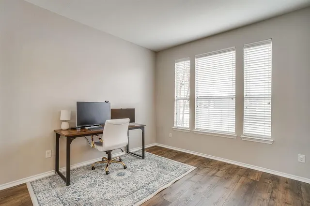 a view of a workspace with furniture and a window