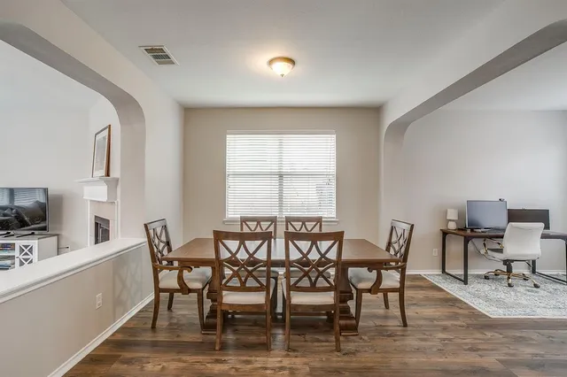 a view of a dining room with furniture and a window