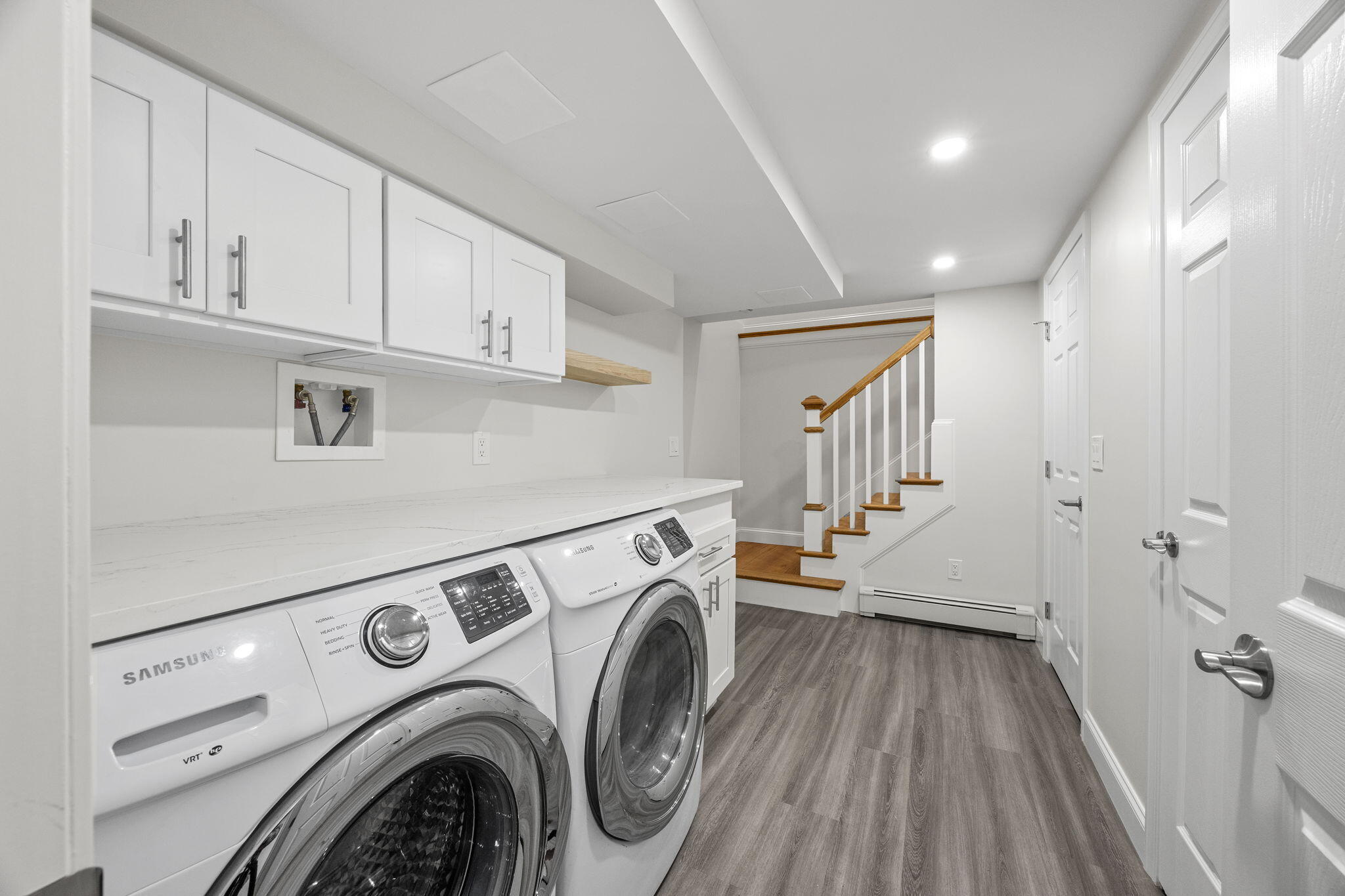 28 Vandermint Lane Hyannis, MA 02601 - Photo 27 of 47 a view of washer and dryer with kitchen in the background