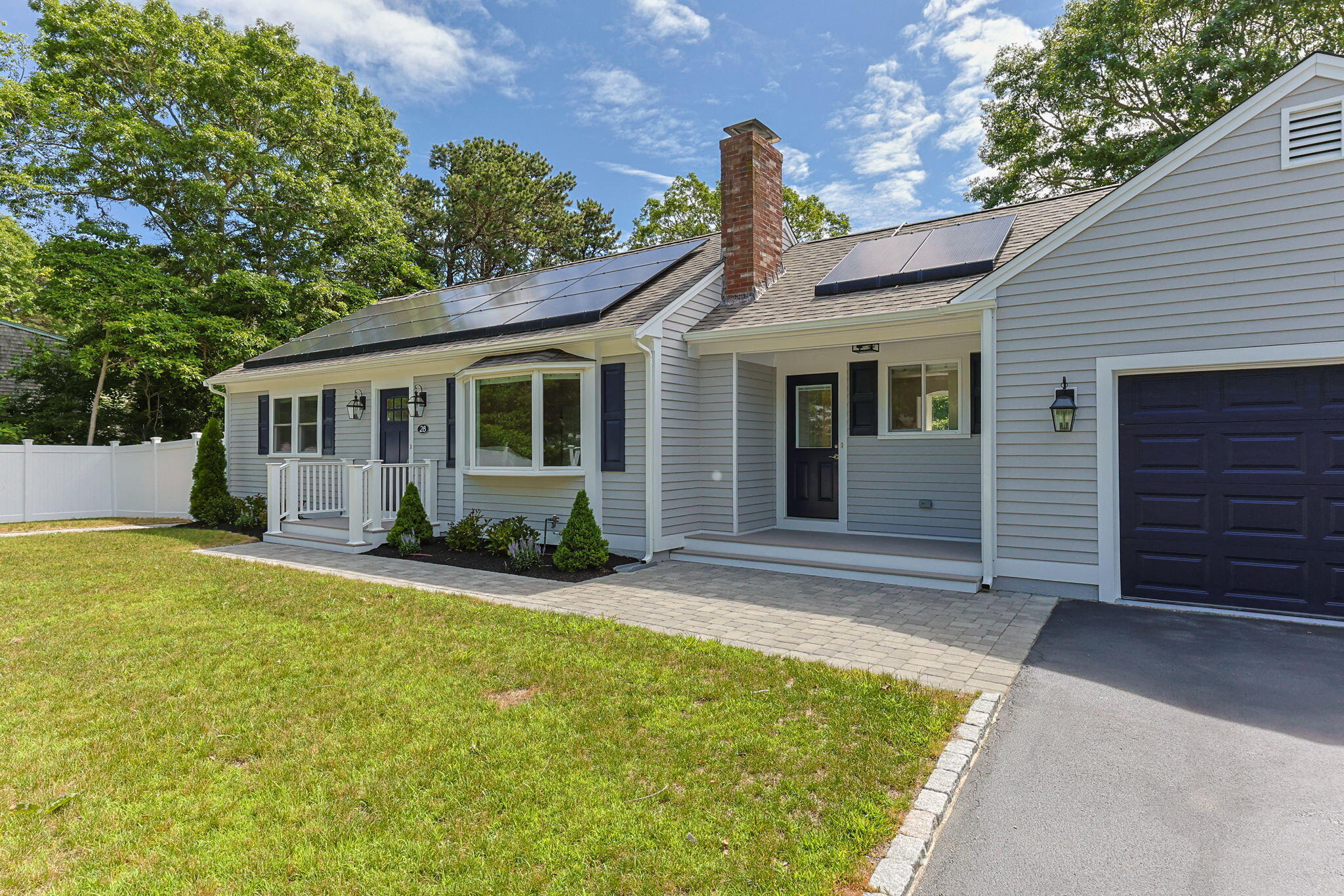 28 Vandermint Lane Hyannis, MA 02601 - Photo 5 of 47 a front view of a house with a yard and potted plants