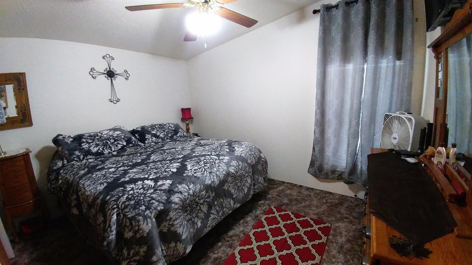5390 Lower River Road Grants Pass, OR 97526 - Photo 16 of 35 a bedroom with a bed and a chandelier